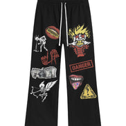 Black pants with various graphic designs on a white background