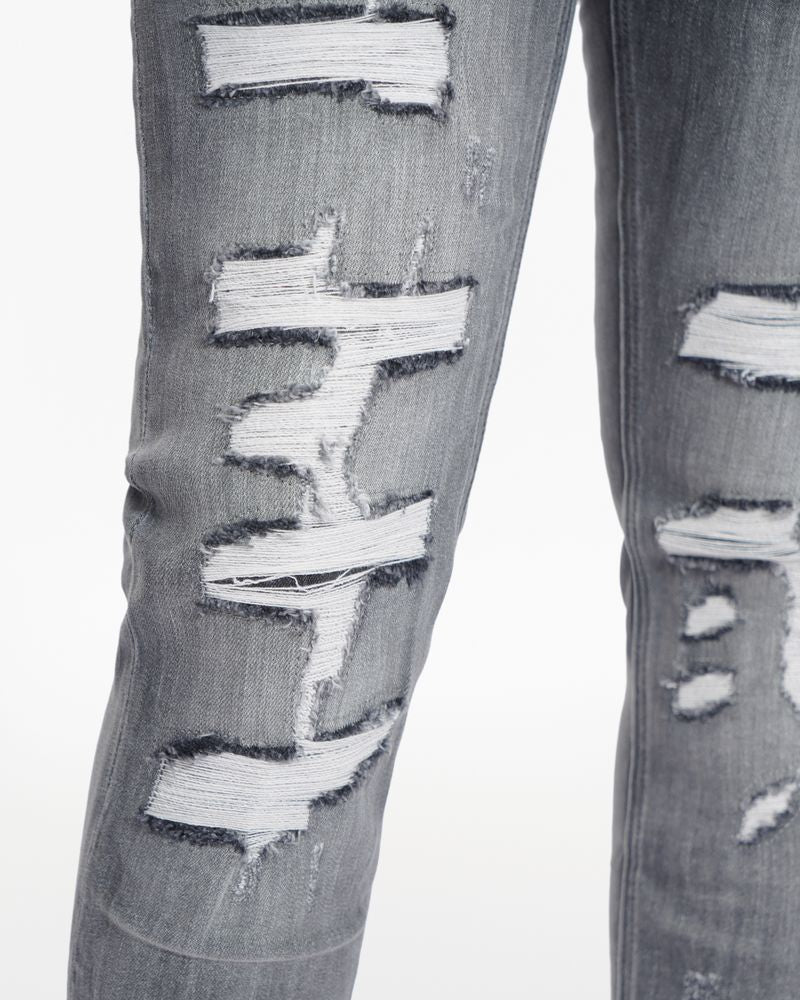 Ripped gray jeans on a white background