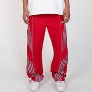 Red pants with white stripes worn by a person on a white background