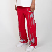 Red pants with white stripes worn by a person on a white background