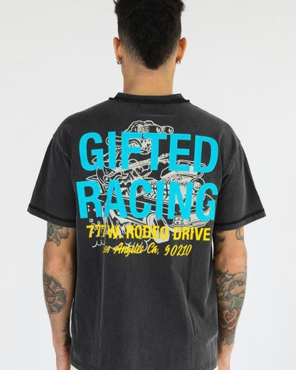 The back of the tee has a large graphic with large blue lettering on top of it. The graphic underneath is a bigger and similar version of the alien on the front. 