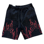 Black shorts with red flame patterns on a white background