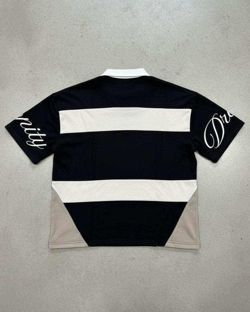 Black and white striped shirt with branding on a gray background