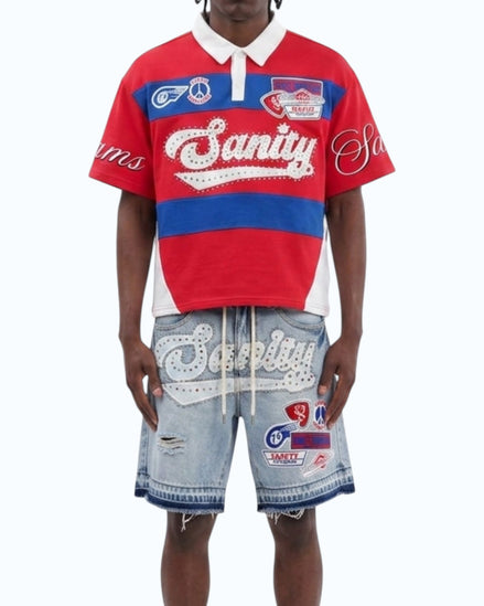 Person wearing a red and blue striped shirt with 'Sanity' branding, paired with matching shorts on a white background.