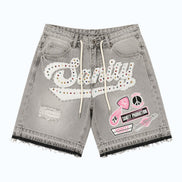 Gray denim shorts with patches and branding on a white background