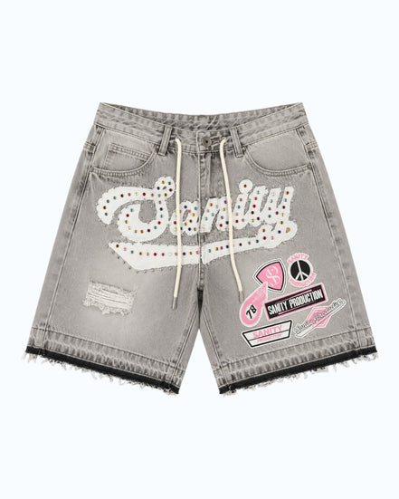 Gray denim shorts with patches and branding on a white background