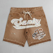 Brown shorts with colorful text and graphics on a gray background