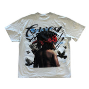 White t-shirt with graphic design of a person with dreadlocks and birds on a white background