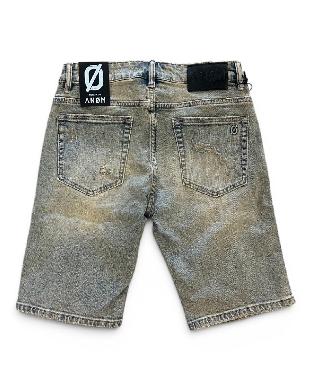 Back view of a distressed denim short with brand label on a white background