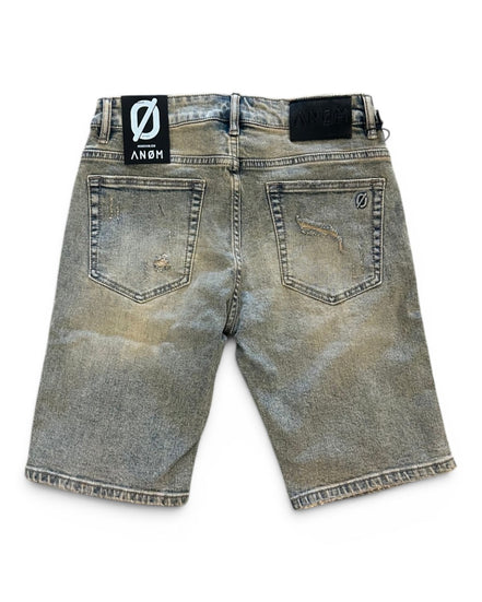 Back view of a distressed denim short with brand label on a white background