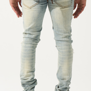 Light blue jeans worn by a person on a white background