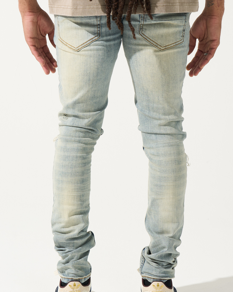 Light blue jeans worn by a person on a white background