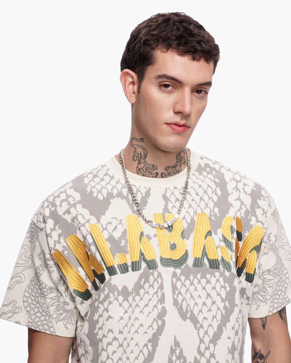 Man wearing a graphic t-shirt with text and design elements on a white background