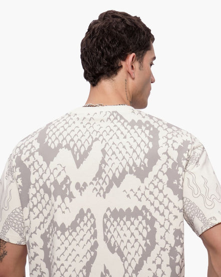 Man wearing a shirt with snake print pattern on a white background