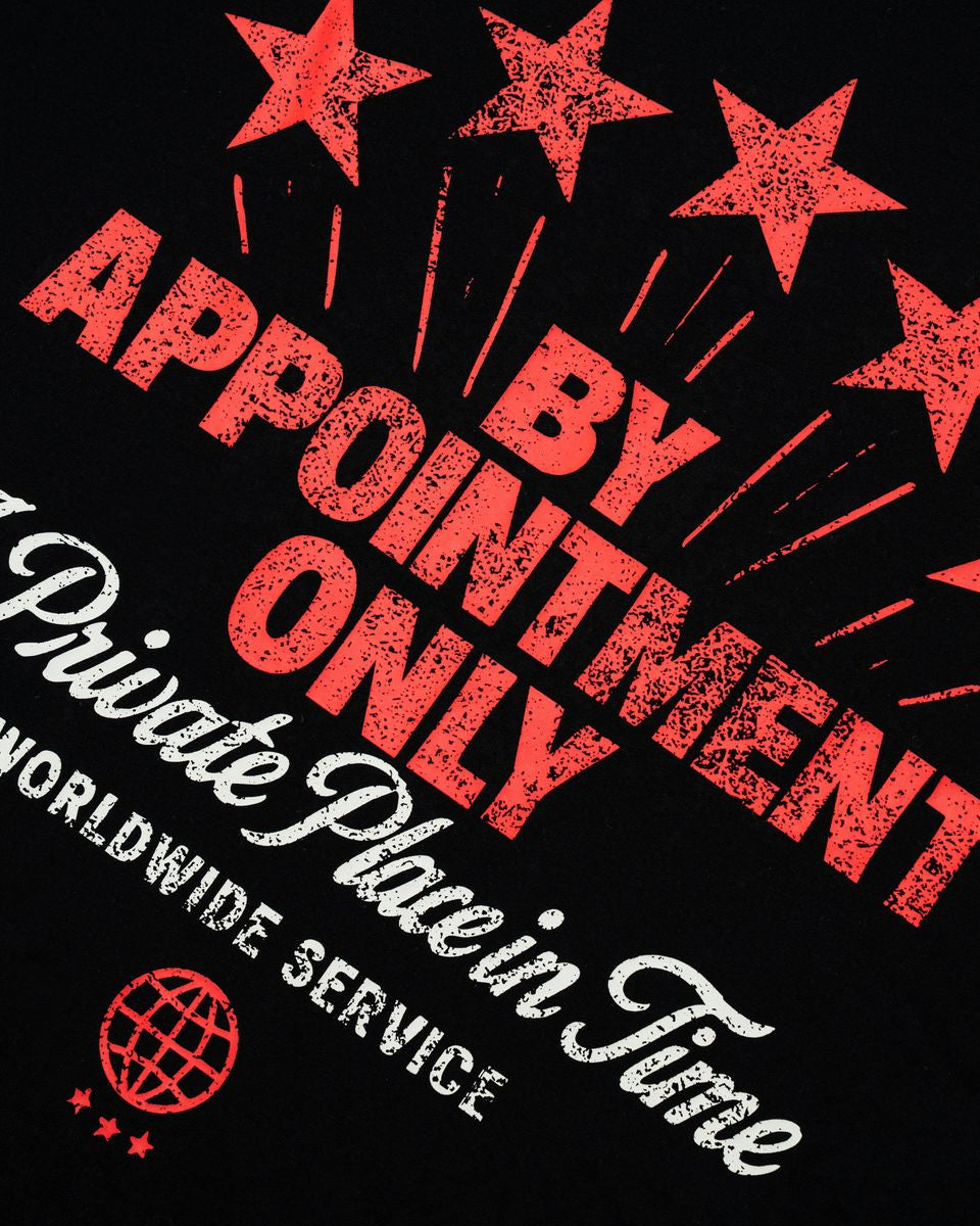 Black shirt with red and white text and star graphics on a black background