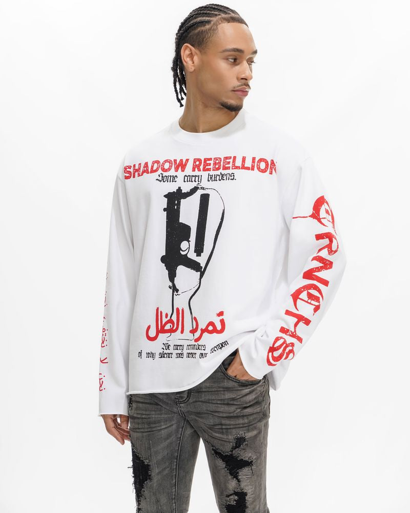 Person wearing a white long-sleeve shirt with red and black graphics and text on a white background