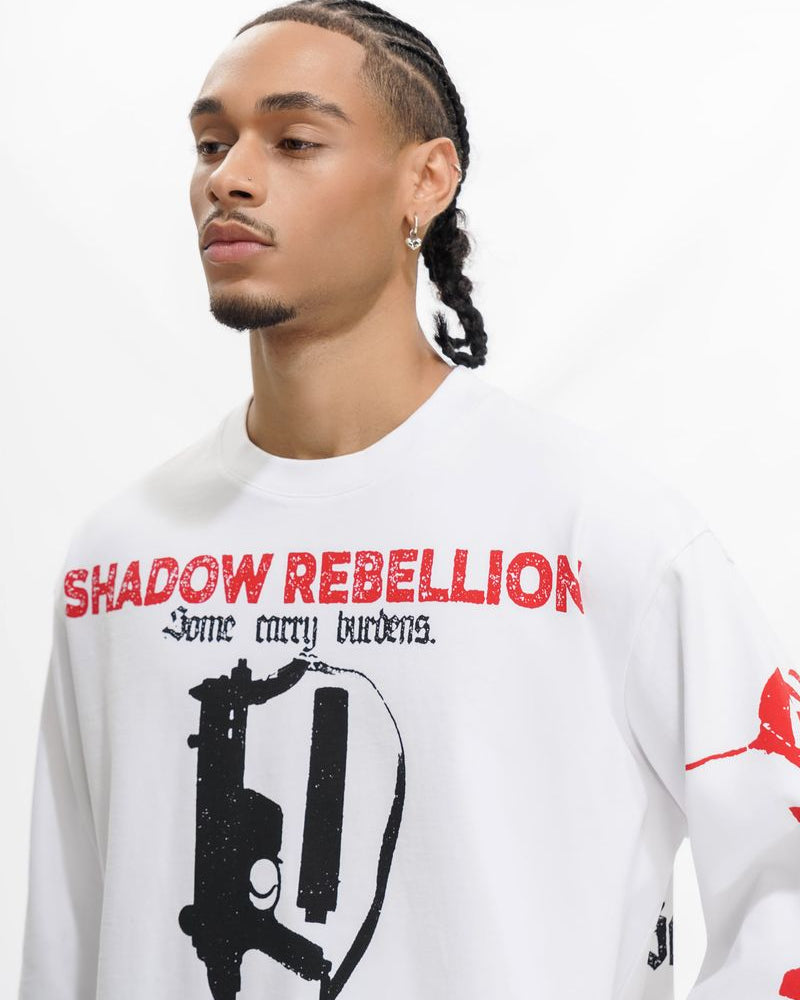 Person wearing a white sweatshirt with 'Shadow Rebellion' graphic design.