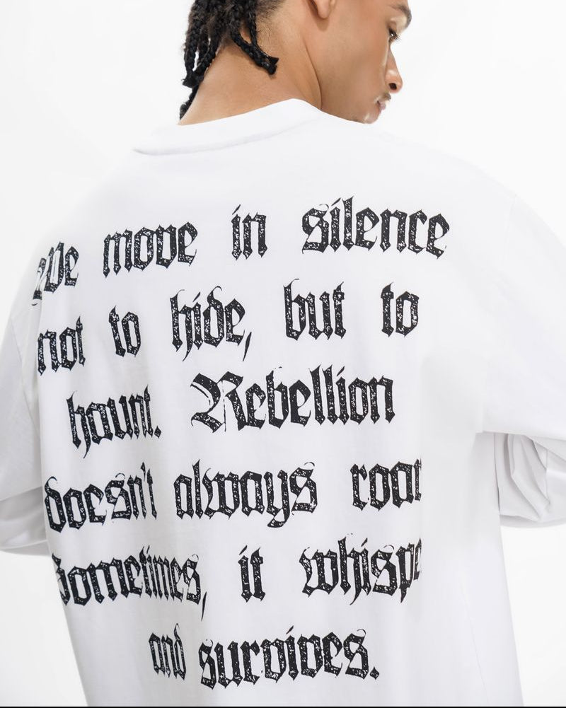 Person wearing a white sweatshirt with black text on the back.