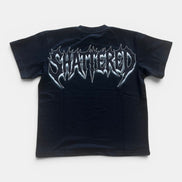 Black t-shirt with 'SHATTERED' graphic design on a white background