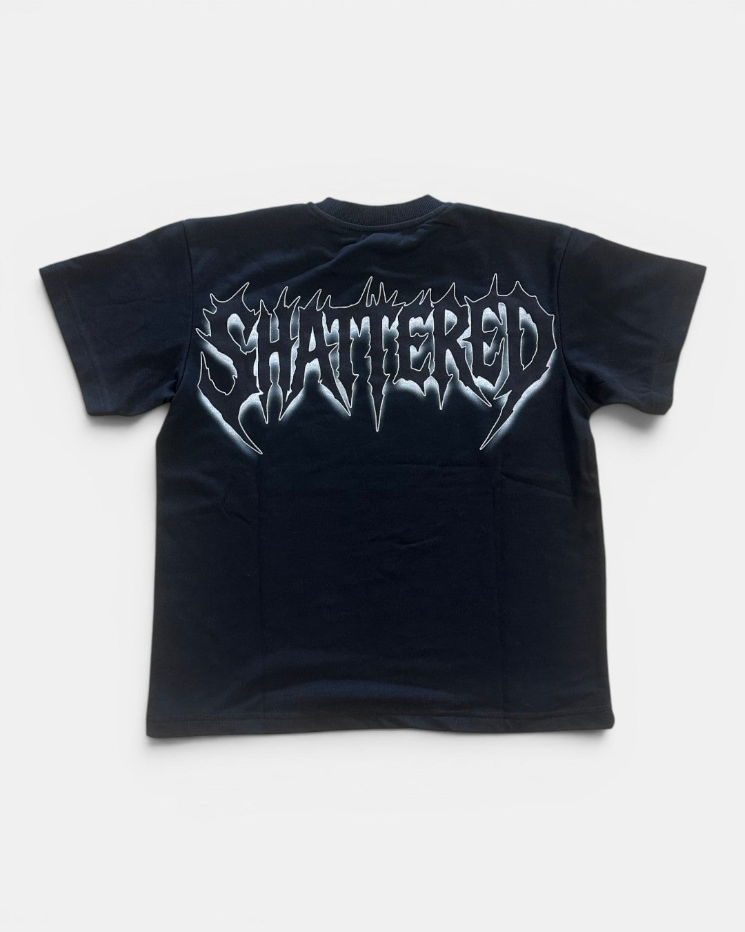 Black t-shirt with 'SHATTERED' graphic design on a white background