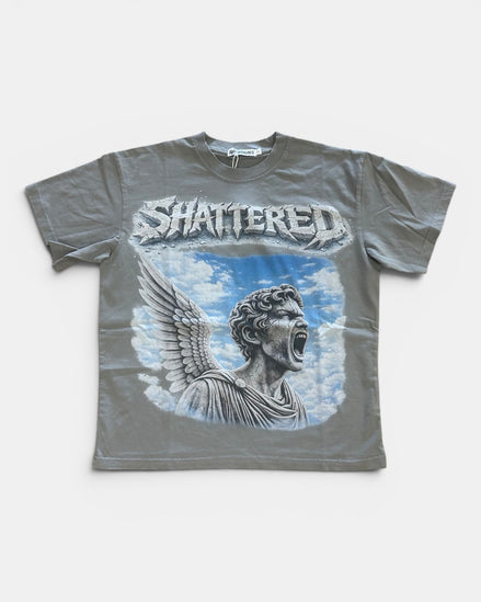 Gray t-shirt with 'Shattered' design featuring a winged figure against a blue sky on a white background.