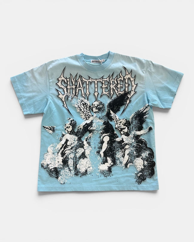 Light blue t-shirt with black and white graphic design and 'Shattered' text on a white background
