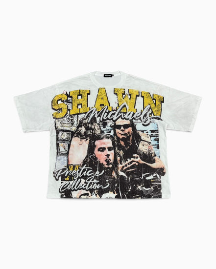 A white graphic t-shirt featuring a distressed print of Shawn Mendes with yellow and black text reading 'SHAWN' and 'Pretend Collection'.