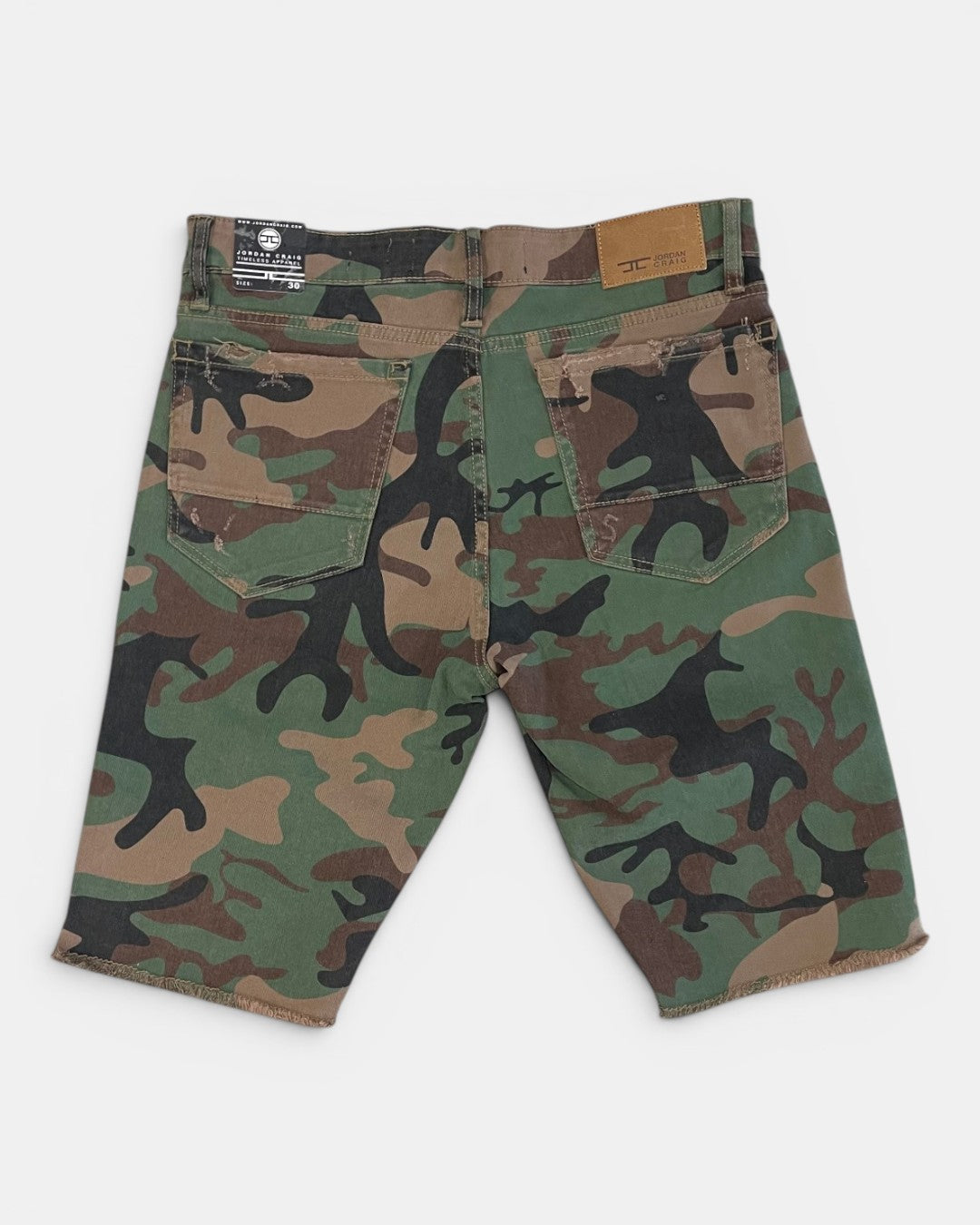 Camouflage shorts with black silhouette designs on a white background