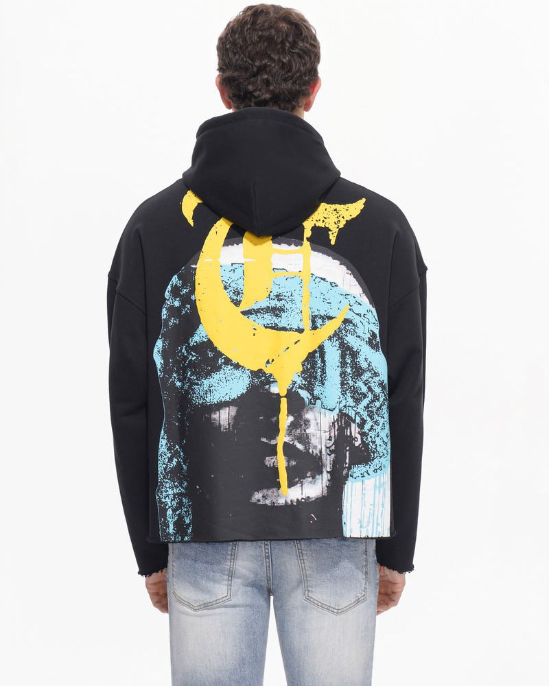 Person wearing a black hoodie with a colorful design on the back against a white background