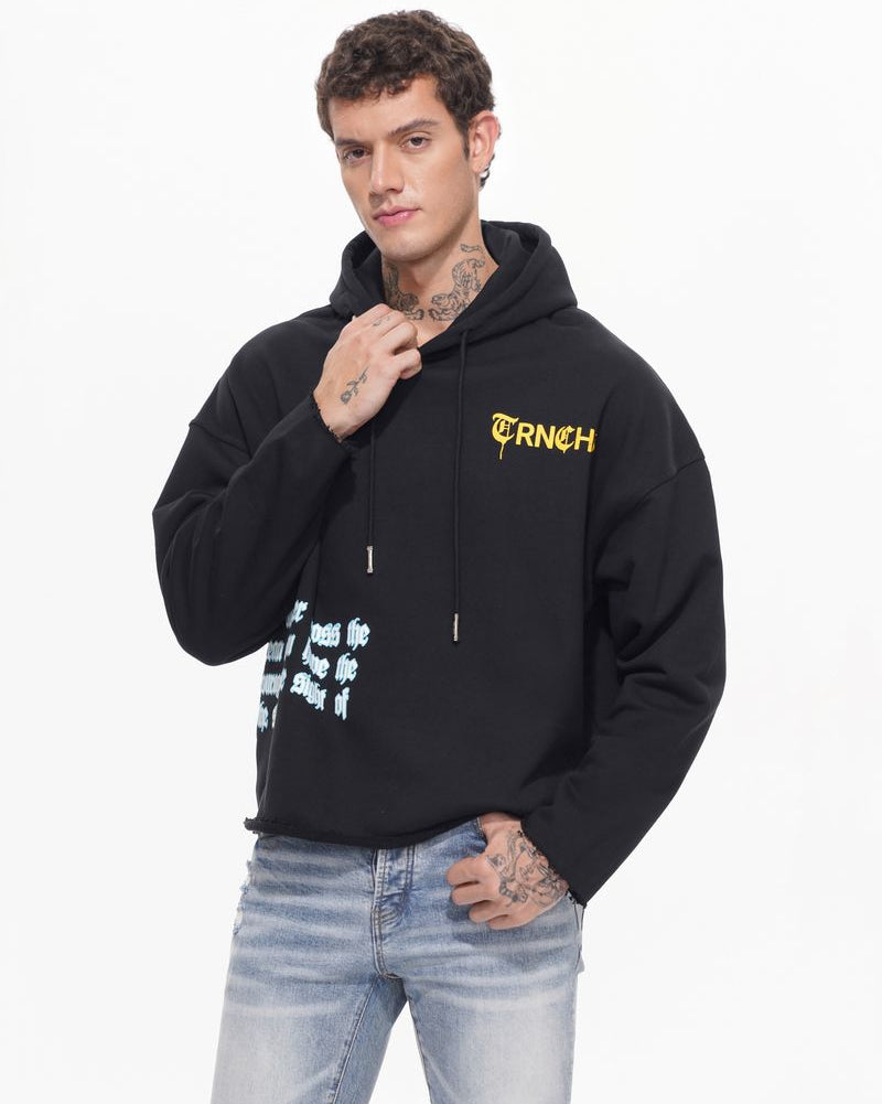 Man wearing a black hoodie with a brand logo on a white background