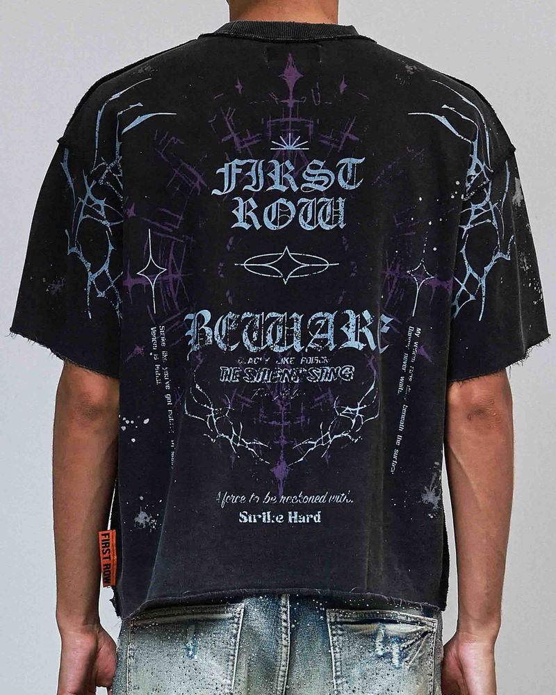 Person wearing a black t-shirt with white text and graphics on a plain background
