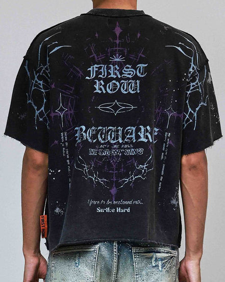 Person wearing a black t-shirt with white text and graphics on a plain background