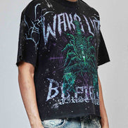 Person wearing a black t-shirt with graphic design and text, standing against a plain background