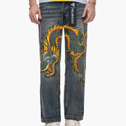 Denim jeans with a dragon design on a white background