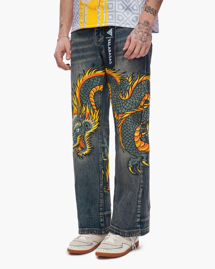 Denim pants with a dragon design worn by a person on a white background