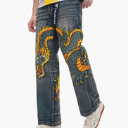 Person wearing blue jeans with a dragon design on a white background