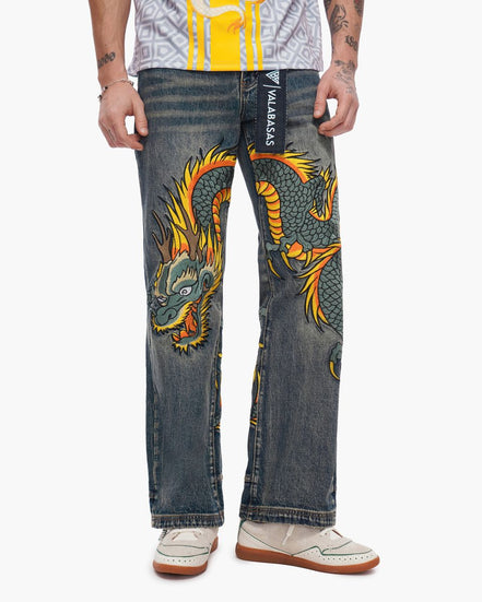 Person wearing jeans with a dragon design and branding.