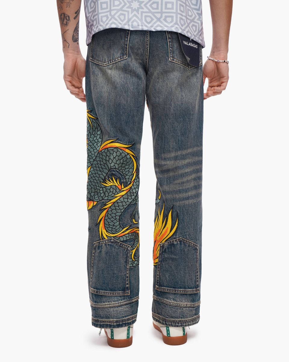 Blue jeans with a dragon design on a white background