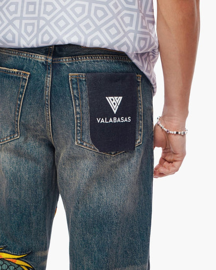 Blue jeans with a visible brand logo on the back pocket against a white background