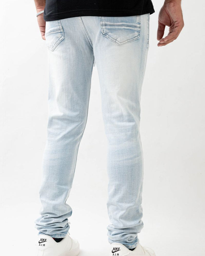 Light blue jeans worn by a person on a white background