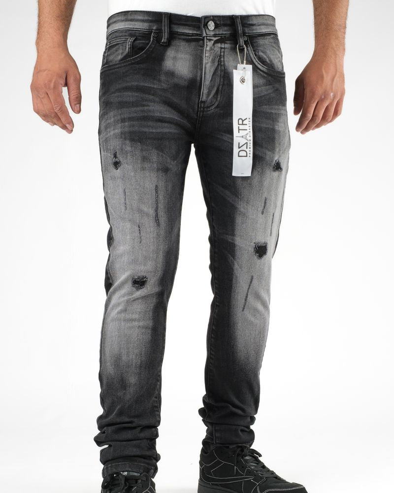 Black distressed jeans with a brand tag on a white background