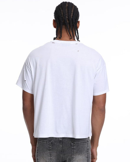 Person wearing a white t-shirt and gray pants on a white background