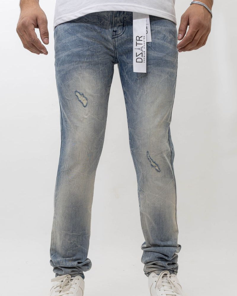 Person wearing light blue jeans with a visible brand label on a white background