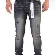 Gray distressed jeans with a brand tag on a white background