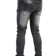 Black jeans worn by a person on a white background