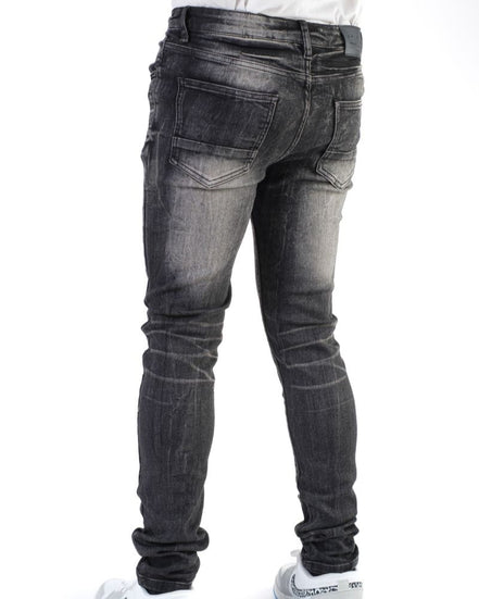 Black jeans worn by a person on a white background