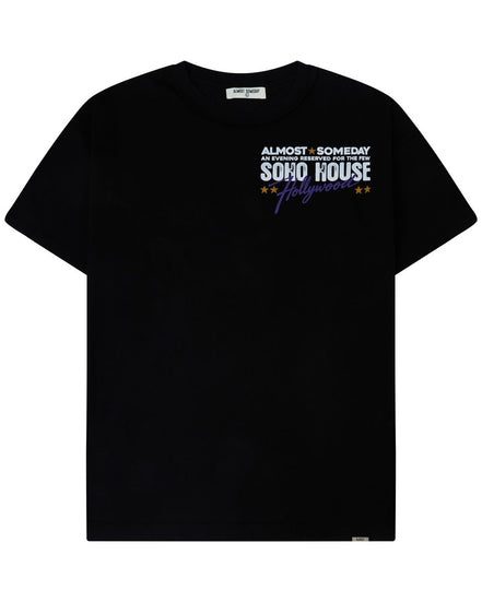 A dark navy blue short-sleeve athletic t-shirt with green trim along the collar, featuring the white 'ALMOST SOMEDAY' brand logo on the right chest and a red and white rugby crest on the left chest.