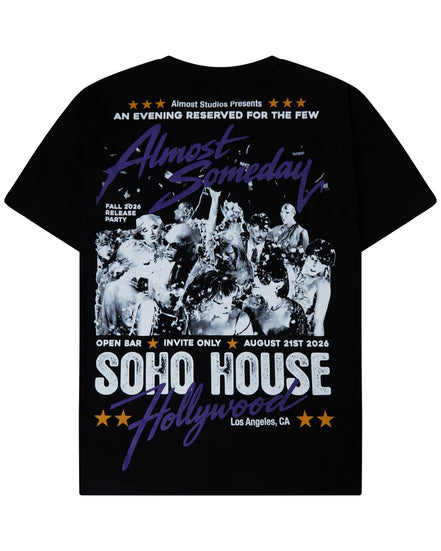 A black short-sleeve graphic t-shirt featuring a vintage-style concert poster design for 'SOHO HOUSE Hollywood' with a black-and-white band photo and purple and white text.