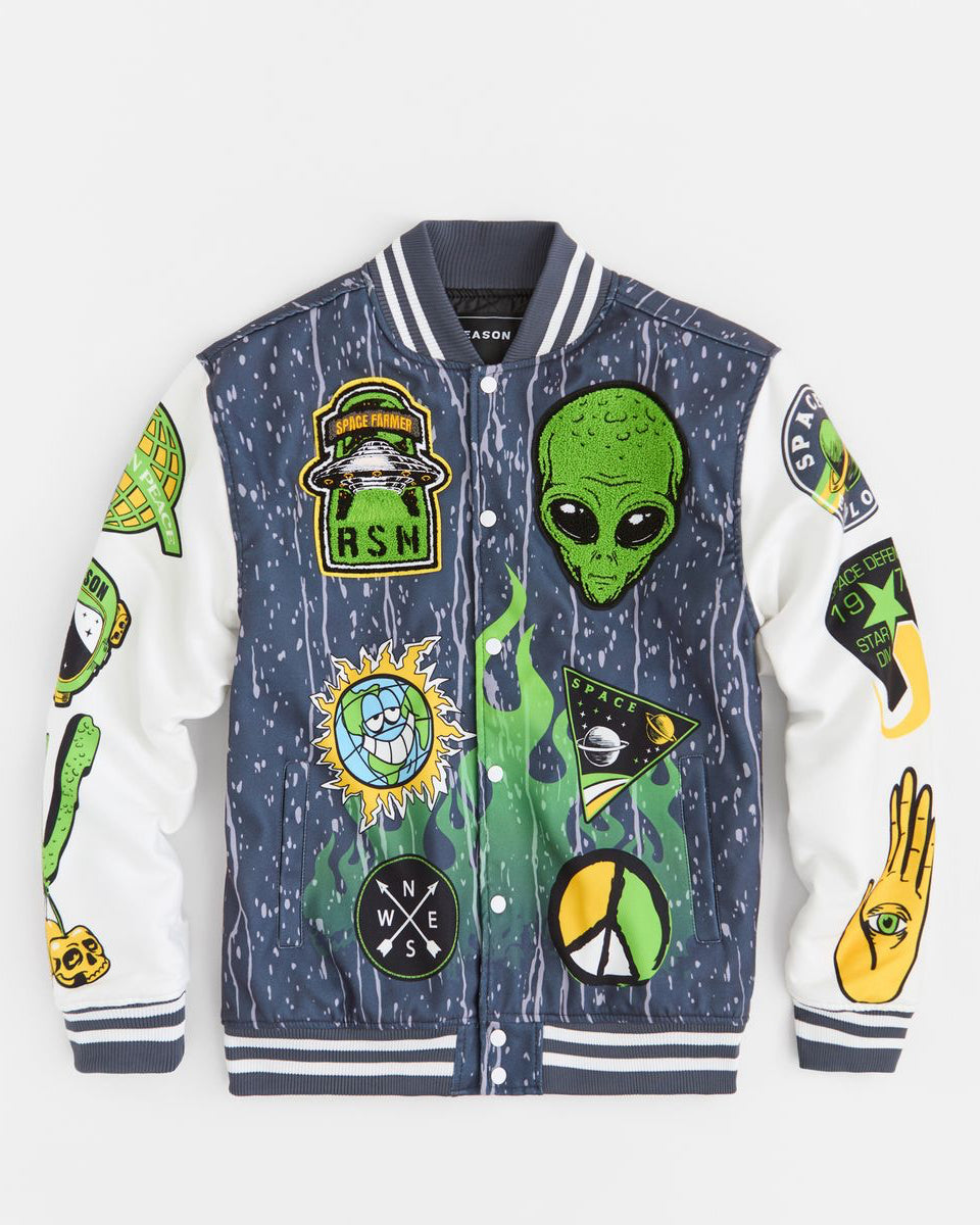 Varsity jacket with alien and peace sign patches on a white background