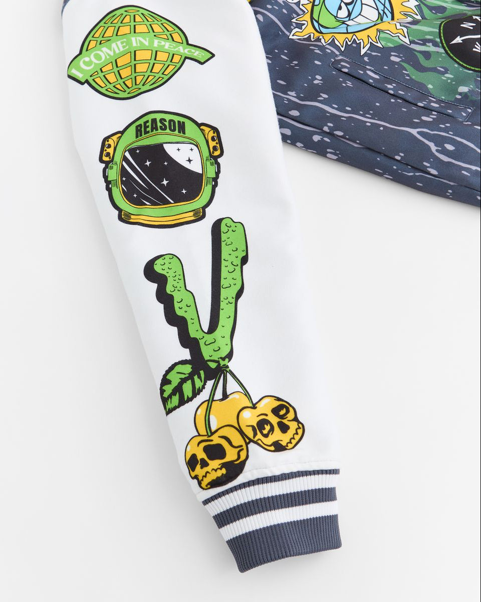 Close-up of a white sleeve with colorful patches including a PAIR OF CHERRIES, space helmet, cactus, and skull on a white background.